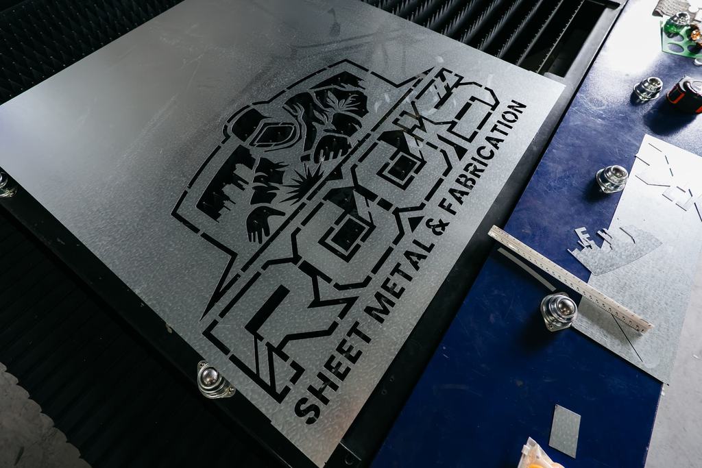 Fiber laser cutting a steel sheet with sparks