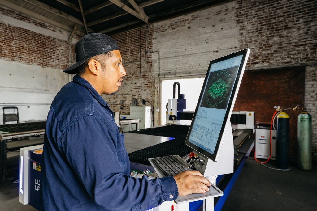 Machinist programming a part at the CNC control screen