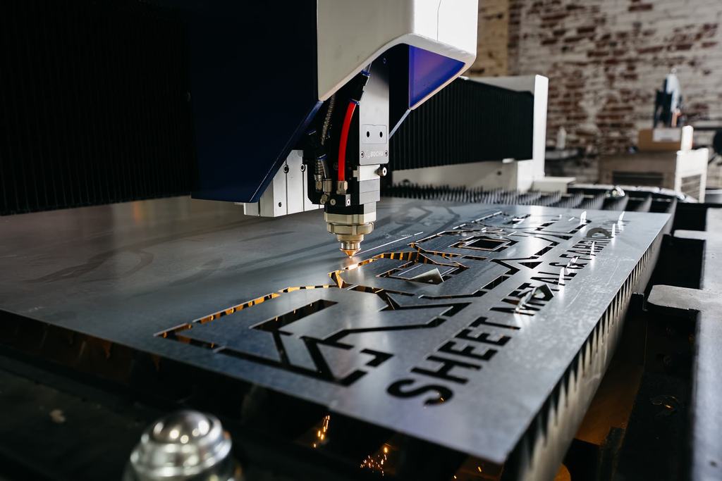 Fiber laser cutting a steel sheet with bright sparks